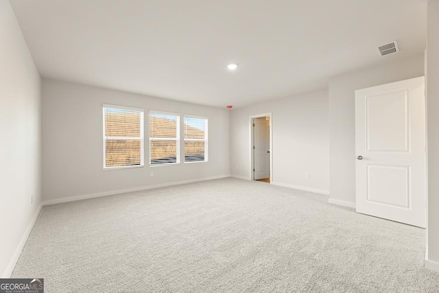 carpeted empty room featuring recessed lighting, baseboards, and visible vents