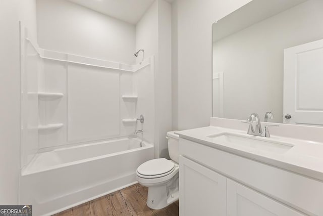 full bath featuring tub / shower combination, wood finished floors, toilet, and vanity