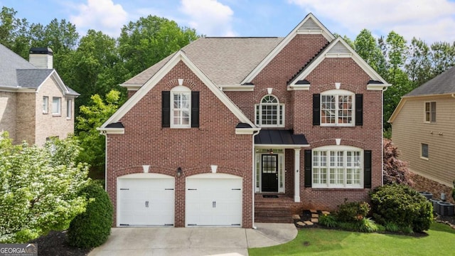12892 Waterside Dr, Milton, GA 30004 - traditional-style house with concrete driveway, brick siding, an attached garage, and central AC unit