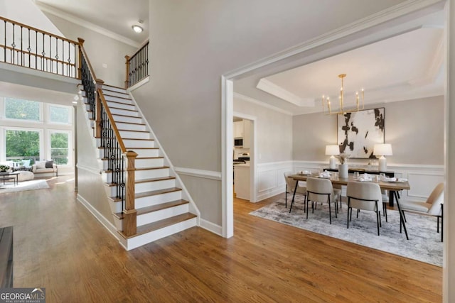 12892 Waterside Dr, Milton, GA 30004 - dining area featuring an inviting chandelier, stairs, crown molding, and wood finished floors