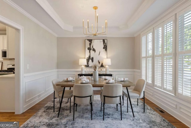 12892 Waterside Dr, Milton, GA 30004 - dining space featuring visible vents, a raised ceiling, wood finished floors, and a chandelier