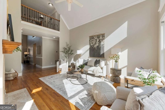 12892 Waterside Dr, Milton, GA 30004 - living area featuring ornamental molding, wood finished floors, baseboards, ceiling fan, and high vaulted ceiling