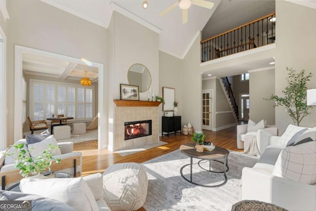 12892 Waterside Dr, Milton, GA 30004 - living room with crown molding, wood finished floors, baseboards, a tile fireplace, and a ceiling fan