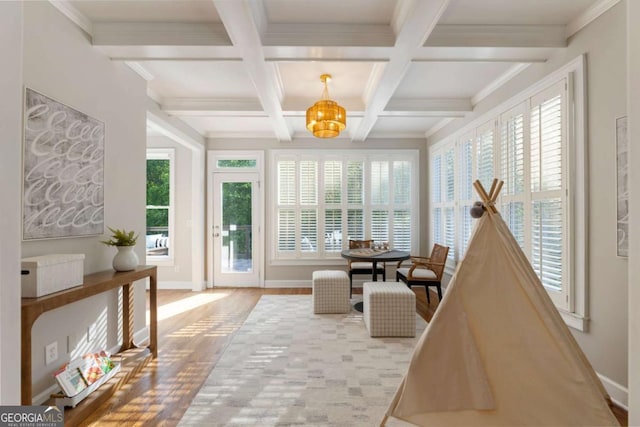 12892 Waterside Dr, Milton, GA 30004 - sitting room featuring healthy amount of natural light, a chandelier, beam ceiling, wood finished floors, and coffered ceiling