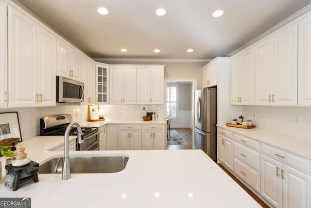 12892 Waterside Dr, Milton, GA 30004 - kitchen with light countertops, appliances with stainless steel finishes, white cabinetry, and glass insert cabinets