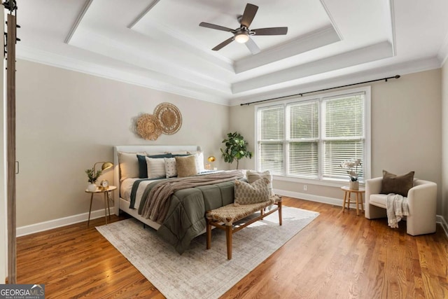 12892 Waterside Dr, Milton, GA 30004 - bedroom with a tray ceiling, light wood-style floors, crown molding, and ceiling fan