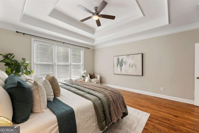 12892 Waterside Dr, Milton, GA 30004 - bedroom with crown molding, a raised ceiling, baseboards, and wood finished floors