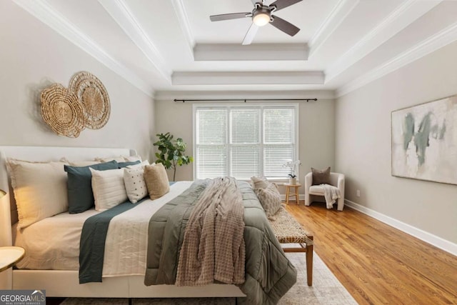 12892 Waterside Dr, Milton, GA 30004 - bedroom featuring crown molding, a raised ceiling, baseboards, and wood finished floors
