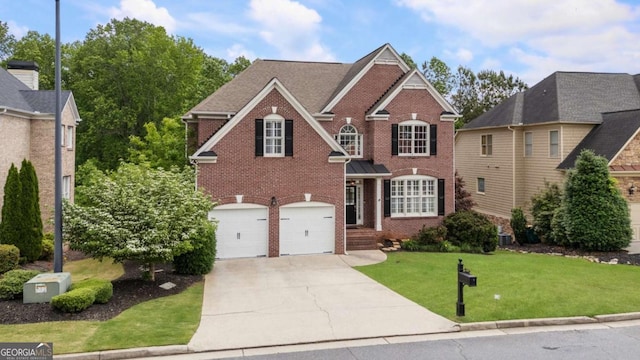 12892 Waterside Dr, Milton, GA 30004 - traditional-style home with brick siding, an attached garage, a front yard, and concrete driveway