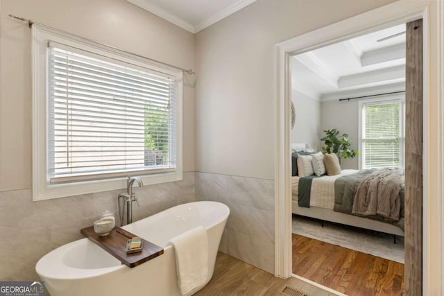 12892 Waterside Dr, Milton, GA 30004 - ensuite bathroom with tile walls, ornamental molding, wood finished floors, and ensuite bath