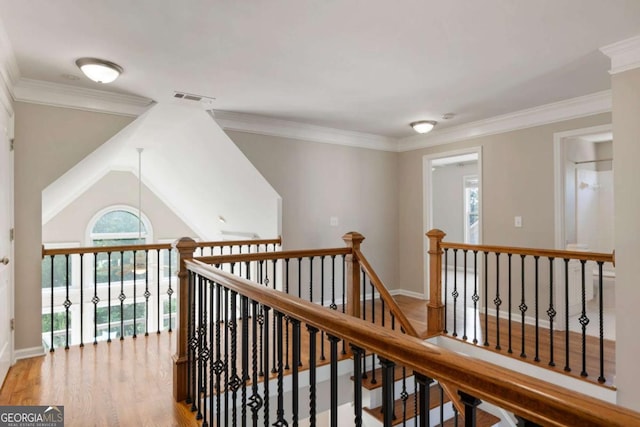 12892 Waterside Dr, Milton, GA 30004 - hall with visible vents, crown molding, wood finished floors, and an upstairs landing