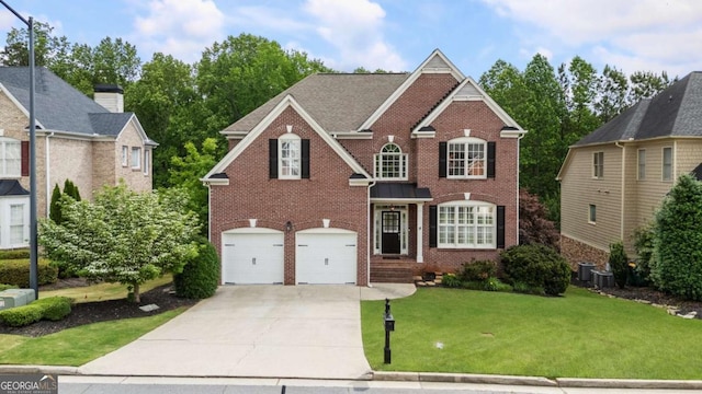 12892 Waterside Dr, Milton, GA 30004 - view of front facade with brick siding, driveway, an attached garage, and a front yard