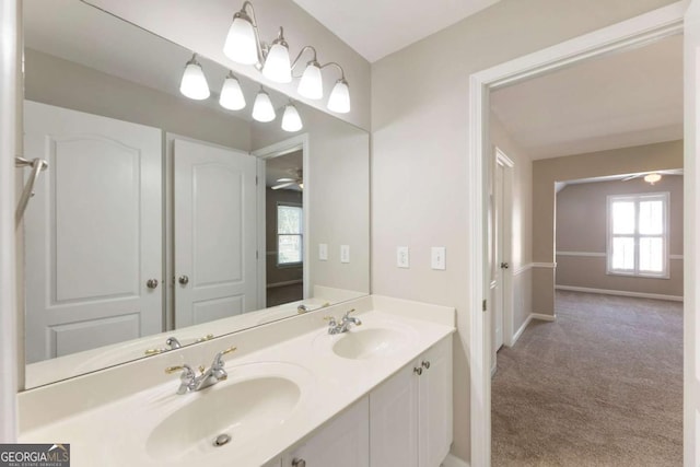 12892 Waterside Dr, Milton, GA 30004 - bathroom featuring baseboards, double vanity, a ceiling fan, and a sink