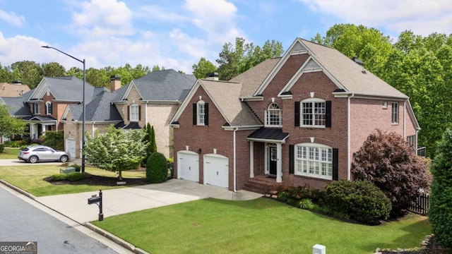 12892 Waterside Dr, Milton, GA 30004 - traditional-style house with brick siding, a garage, a front yard, and concrete driveway
