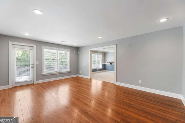 12892 Waterside Dr, Milton, GA 30004 - unfurnished living room with baseboards, recessed lighting, and wood finished floors