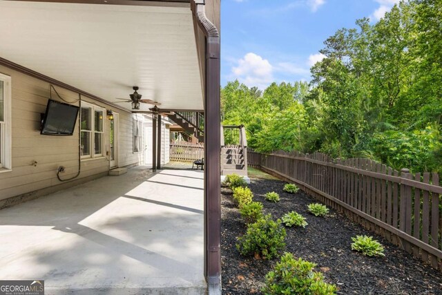 12892 Waterside Dr, Milton, GA 30004 - view of patio / terrace with stairs, a fenced backyard, and ceiling fan