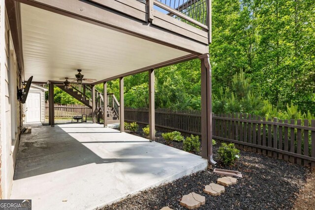 12892 Waterside Dr, Milton, GA 30004 - view of patio / terrace featuring stairs, ceiling fan, a shed, a fenced backyard, and an outbuilding