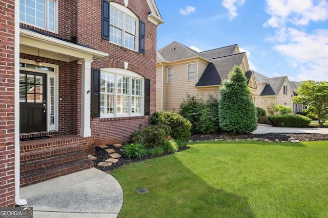 12892 Waterside Dr, Milton, GA 30004 - doorway to property featuring brick siding and a yard