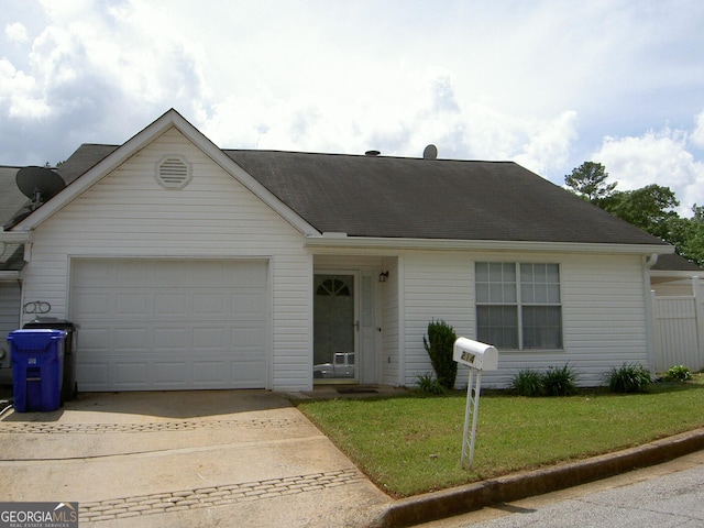 214 Oak Cir, Stockbridge, GA 30281 - view of front of house featuring an attached garage, driveway, roof with shingles, and a front lawn