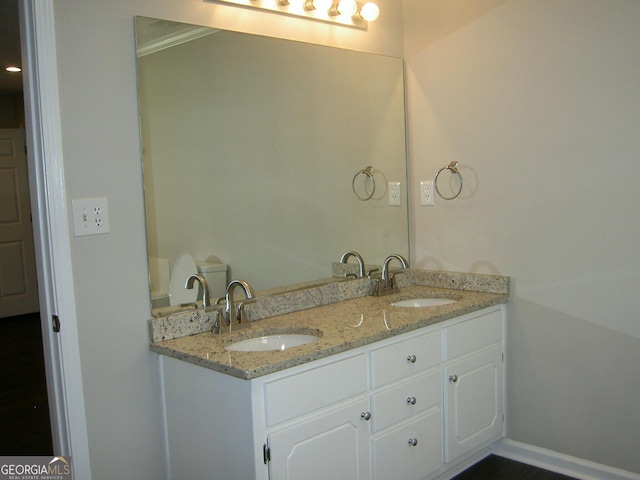 214 Oak Cir, Stockbridge, GA 30281 - bathroom featuring a sink, baseboards, and double vanity