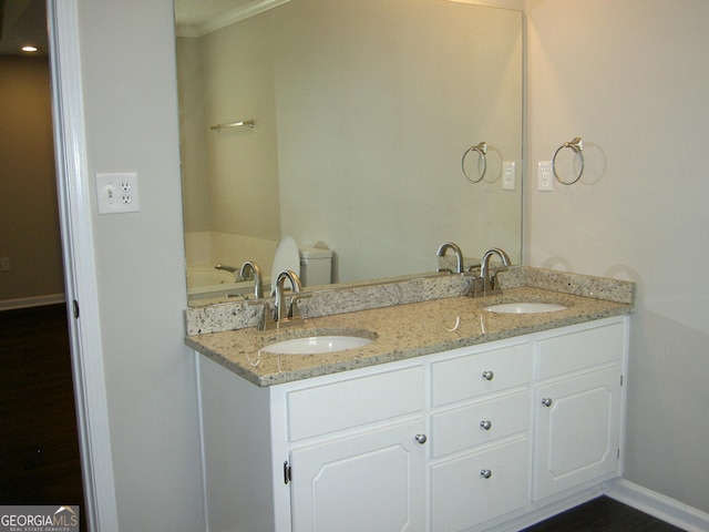 214 Oak Cir, Stockbridge, GA 30281 - full bath featuring a sink, baseboards, crown molding, and double vanity