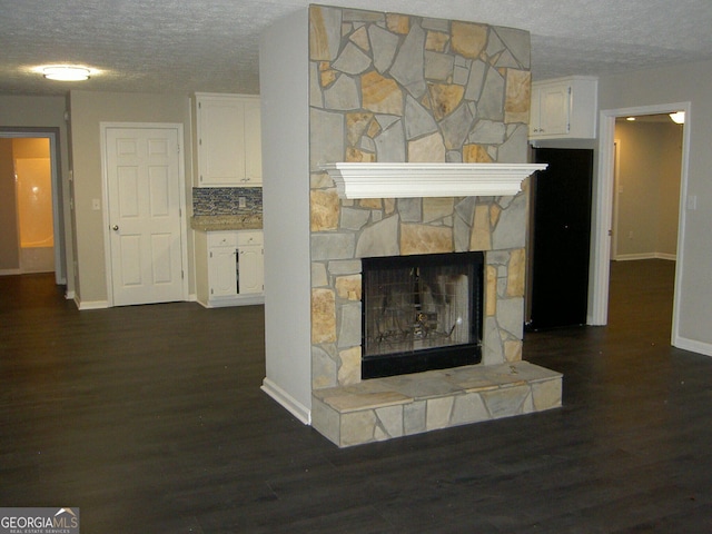 214 Oak Cir, Stockbridge, GA 30281 - details with a textured ceiling, baseboards, and wood finished floors