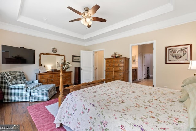 bedroom with a raised ceiling and ornamental molding