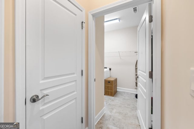 hall with visible vents and baseboards