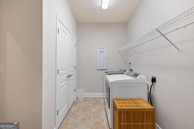clothes washing area featuring baseboards, laundry area, washer and clothes dryer, and electric panel