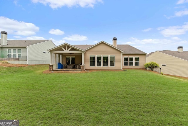 back of house with a lawn, ceiling fan, and a patio