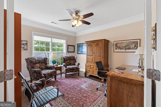 office with a ceiling fan, baseboards, wood finished floors, visible vents, and ornamental molding