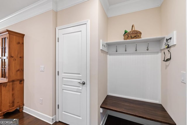 mudroom with crown molding, baseboards, and dark wood finished floors