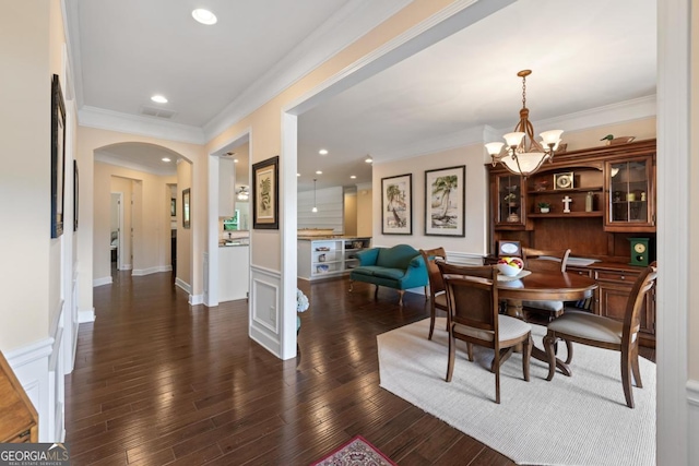 dining space featuring arched walkways, an inviting chandelier, ornamental molding, and visible vents