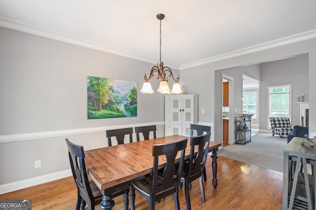 68 Timber Creek Estates Dr, Sharpsburg, GA 30277 - dining space featuring crown molding, baseboards, a notable chandelier, and wood finished floors