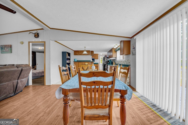 187 New Hope Rd, Canon, GA 30520 - dining area with ornamental molding, vaulted ceiling, light wood-type flooring, and a textured ceiling