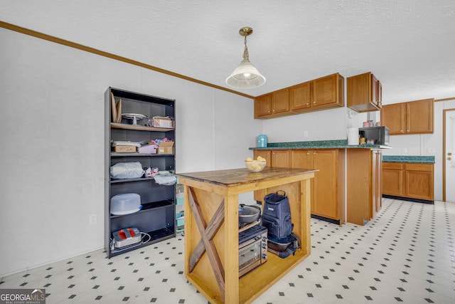 187 New Hope Rd, Canon, GA 30520 - kitchen featuring ornamental molding, dark countertops, light floors, a textured ceiling, and decorative light fixtures