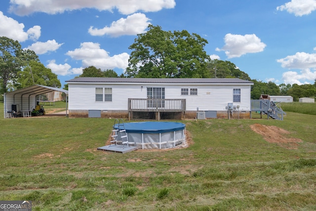 187 New Hope Rd, Canon, GA 30520 - rear view of house featuring metal roof, a wooden deck, central AC, a yard, and a covered pool