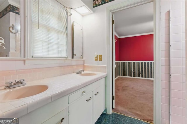 full bath with double vanity and ornamental molding