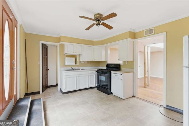 kitchen with gas stove, light countertops, a ceiling fan, white cabinets, and a sink