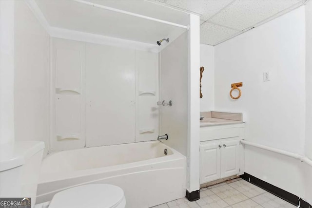 full bath with toilet, a drop ceiling, shower / washtub combination, and vanity