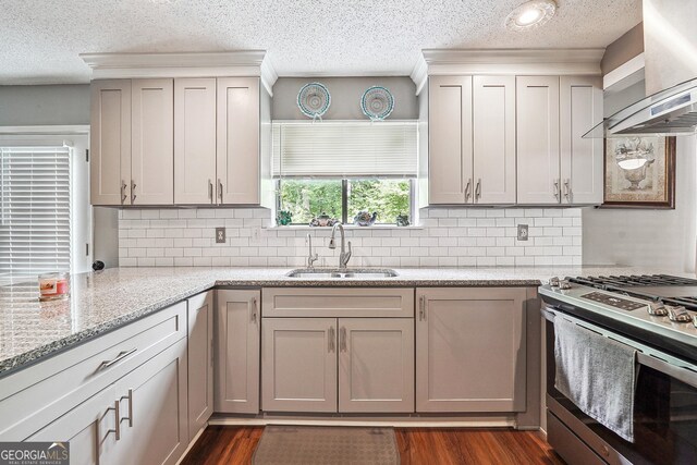 5022 Audubon Pl, Norcross, GA 30093 - kitchen featuring a sink, stainless steel gas range oven, a textured ceiling, dark wood finished floors, and wall chimney exhaust hood
