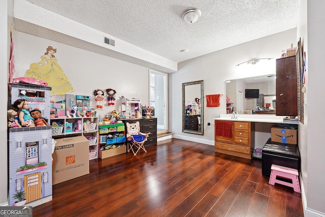 5022 Audubon Pl, Norcross, GA 30093 - playroom featuring visible vents, a textured ceiling, and wood finished floors