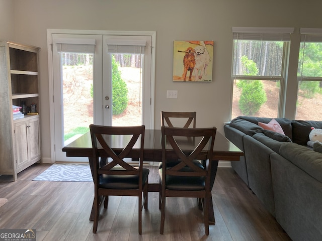 dining area with french doors and wood finished floors
