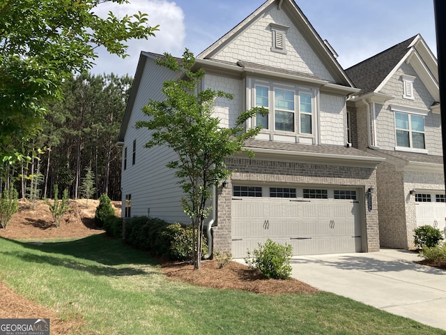 view of front of home with a front lawn, roof with shingles, brick siding, concrete driveway, and an attached garage