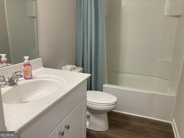 full bath with toilet, shower / bath combo with shower curtain, wood finished floors, and vanity