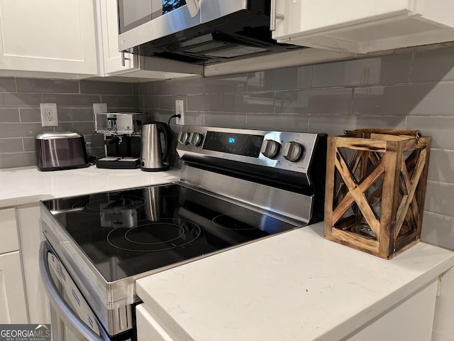 1074 Hobson St, Atlanta, GA 30310 - kitchen with white cabinets, light stone countertops, stainless steel appliances, and tasteful backsplash