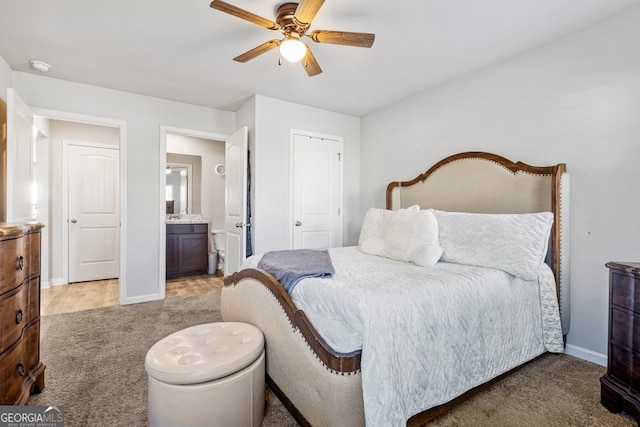 400 Toronto Cir, Hampton, GA 30228 - bedroom with baseboards, ceiling fan, light carpet, and connected bathroom