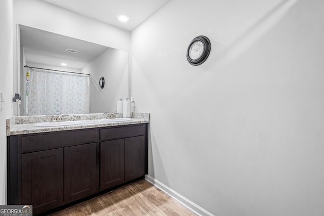 400 Toronto Cir, Hampton, GA 30228 - bathroom featuring double vanity, baseboards, a sink, and wood finished floors