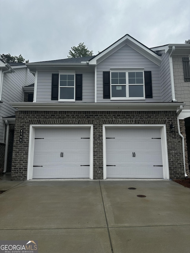 1155 Park Center Cir NW, Austell, GA 30168 - exterior space featuring brick siding, an attached garage, and driveway
