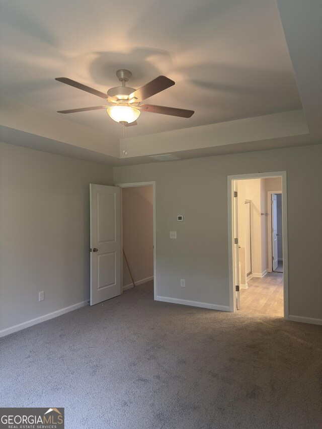 1155 Park Center Cir NW, Austell, GA 30168 - carpeted empty room featuring baseboards, ceiling fan, and a raised ceiling